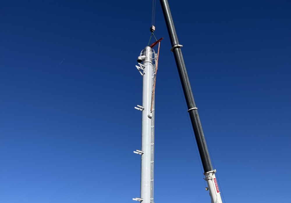 a large metal tower with a crane