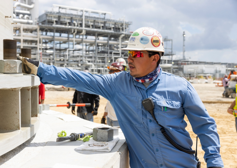 a man wearing a hard hat and glasses