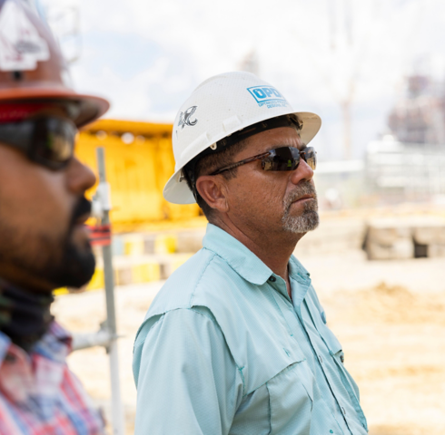 a group of men wearing hard hats