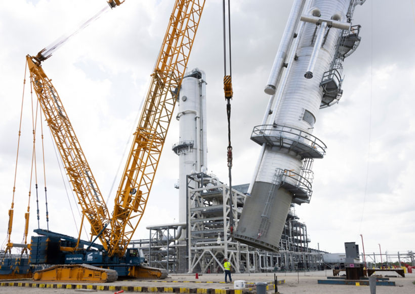a crane lifting a large machine