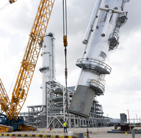 a crane lifting a large machine