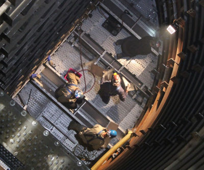 a group of people working on a machine