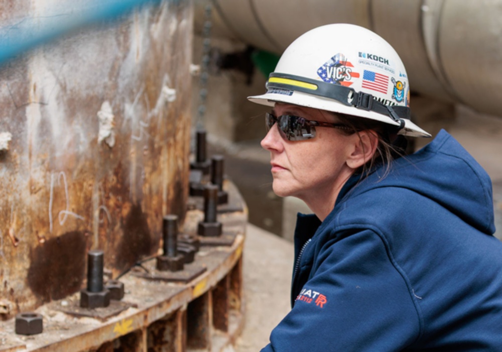 a woman wearing a hard hat and sunglasses
