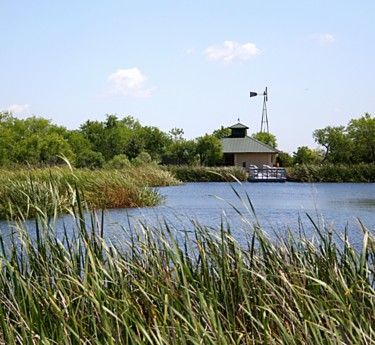 a small building in the middle of a lake