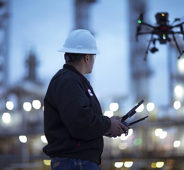 a man in a hard hat holding a drone