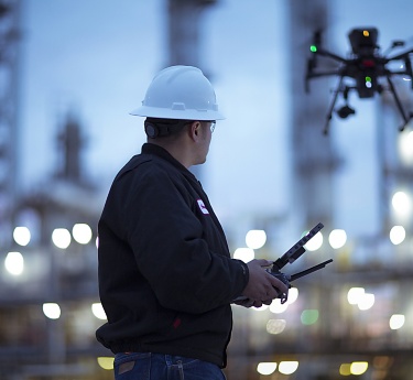 a man in a hard hat holding a drone
