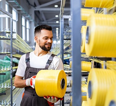 a man holding a roll of yellow plastic