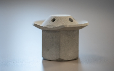 a small grey object with holes