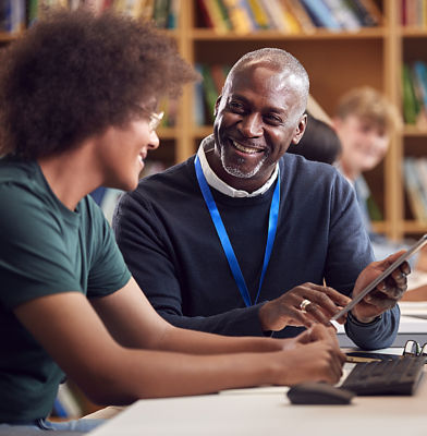 a man and woman looking at a tablet