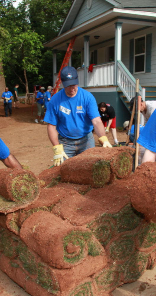 a group of people rolling grass rolls