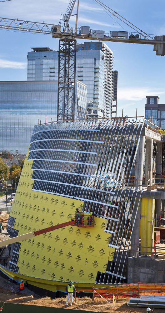 a construction site with a crane and a building