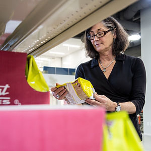 a woman looking at a package