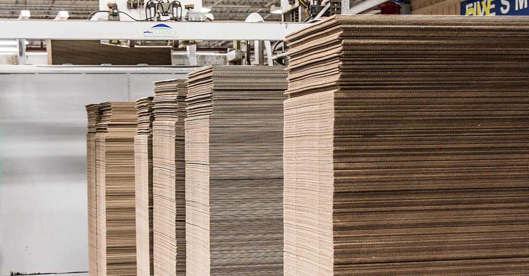 a large stack of cardboard in a warehouse