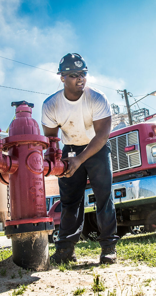 a man holding a fire hydrant