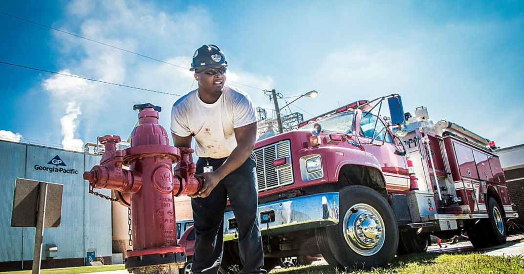 a man holding a fire hydrant