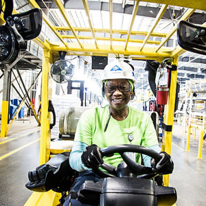 a woman driving a forklift