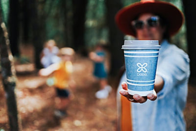a woman holding a cup of coffee
