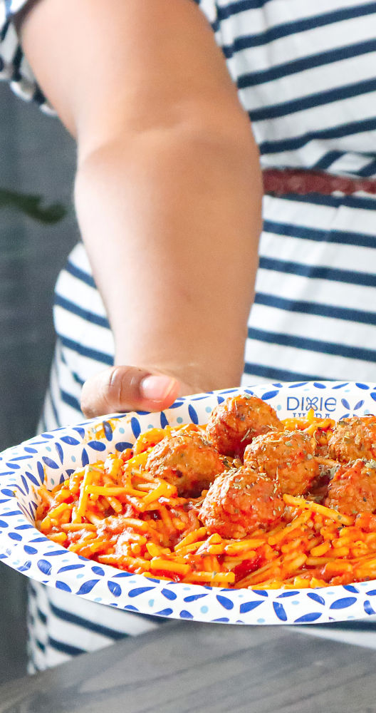 a person holding a plate of food