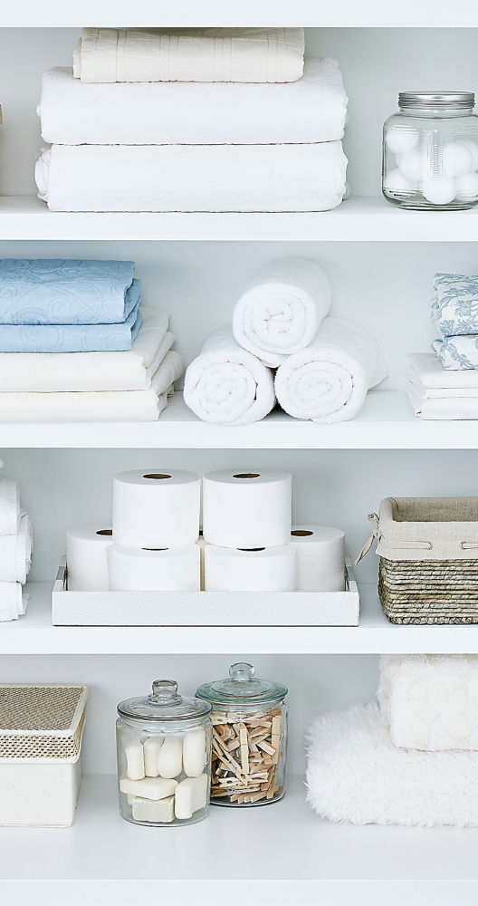 a shelf with towels and toilet paper