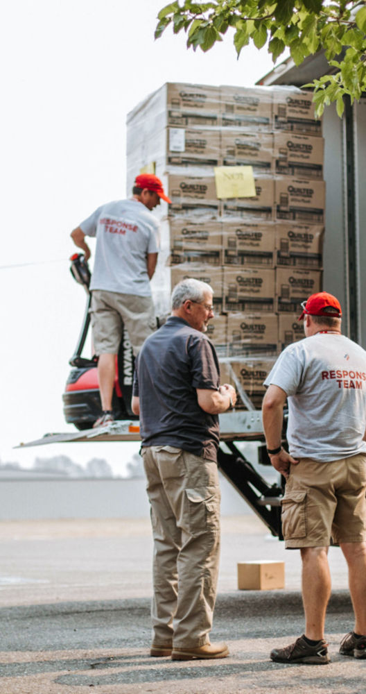 a group of men loading boxes into a truck