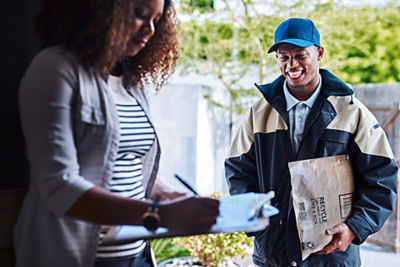 a man and woman looking at a package