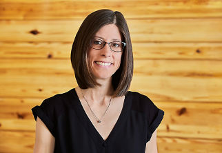 a woman wearing glasses and a black shirt