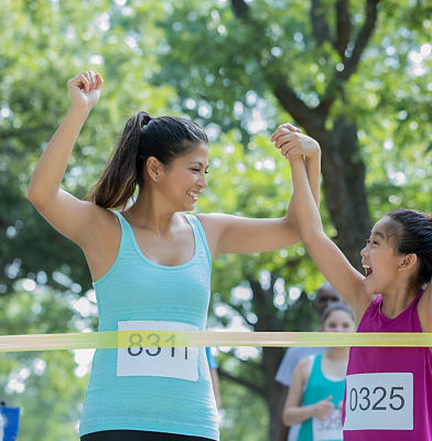 a woman and a girl celebrating a race