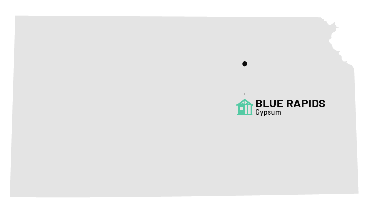 a white card with a black and green house and a black dot