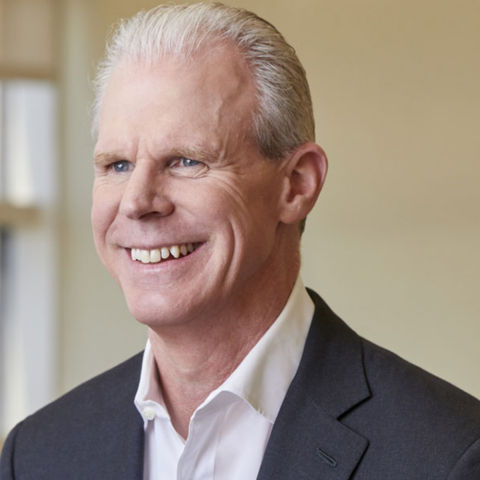 a man in a suit smiling