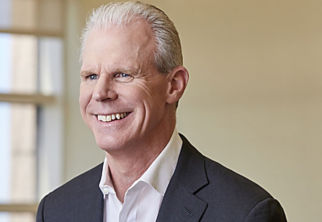 a man in a suit smiling