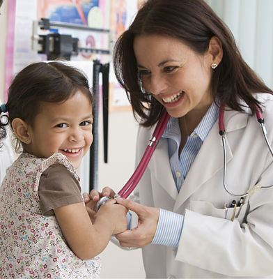 a doctor and a child smiling