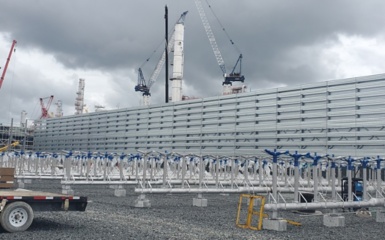 a large white wall with blue fans