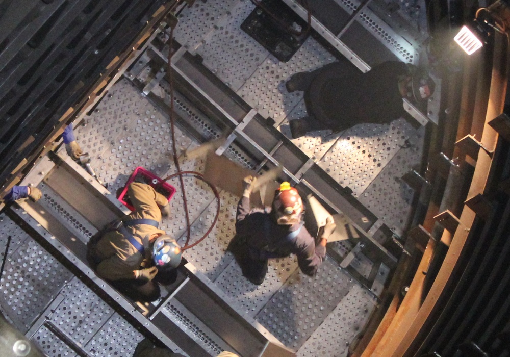 a high angle view of people working on a machine