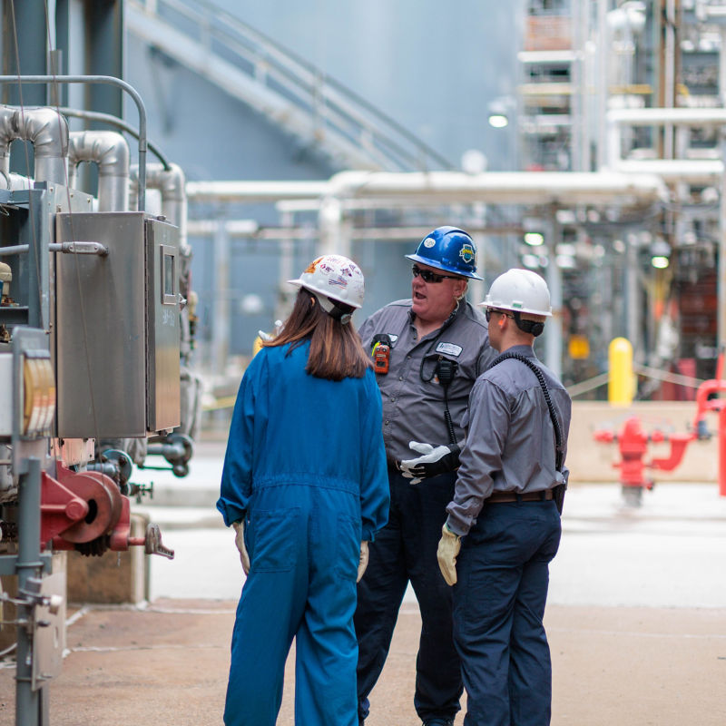 a group of people in hard hats