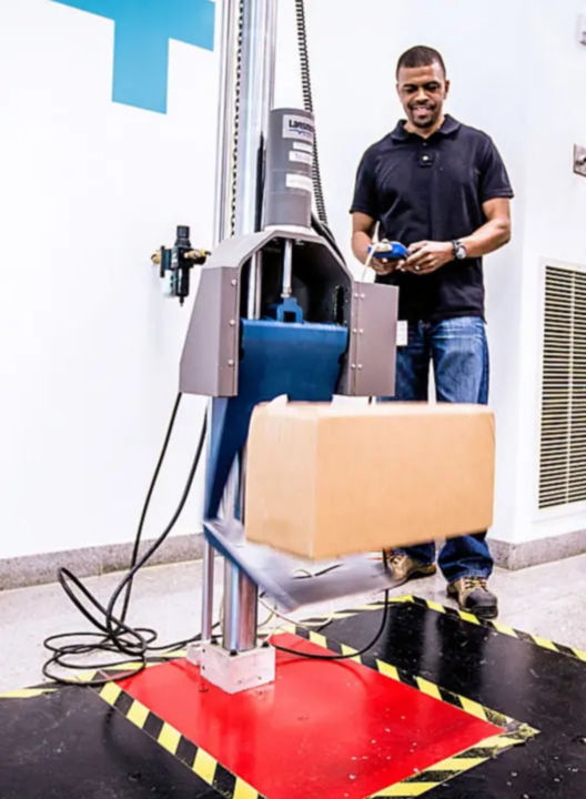 a man standing next to a machine