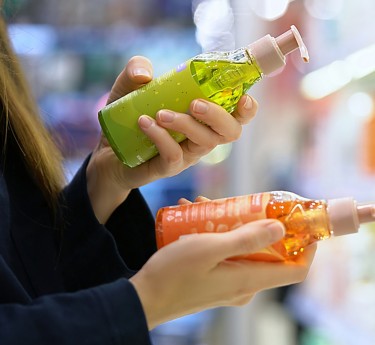 a person holding bottles of liquid