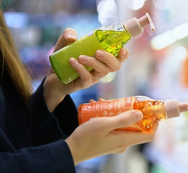 a person holding bottles of liquid