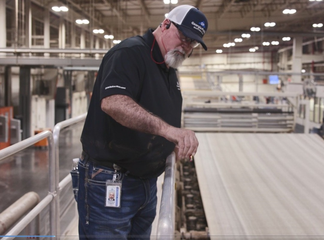 Harold Summers, reliability manager, points out different parts of the double backer belt.