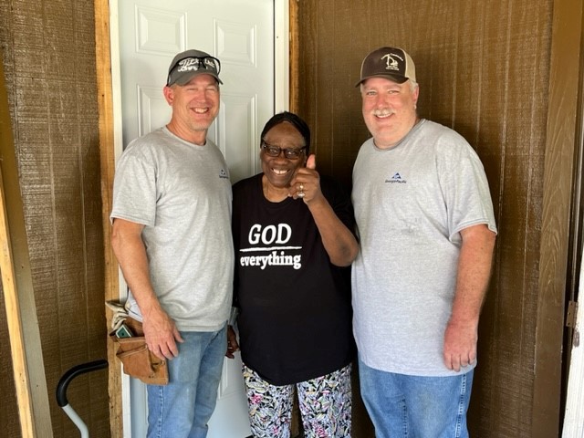 Mrs. Mable Johnson shows her appreciation to the GP Operation Clean Sweep crew for her new door.