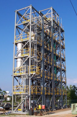 a large metal tower with yellow and gray scaffolding