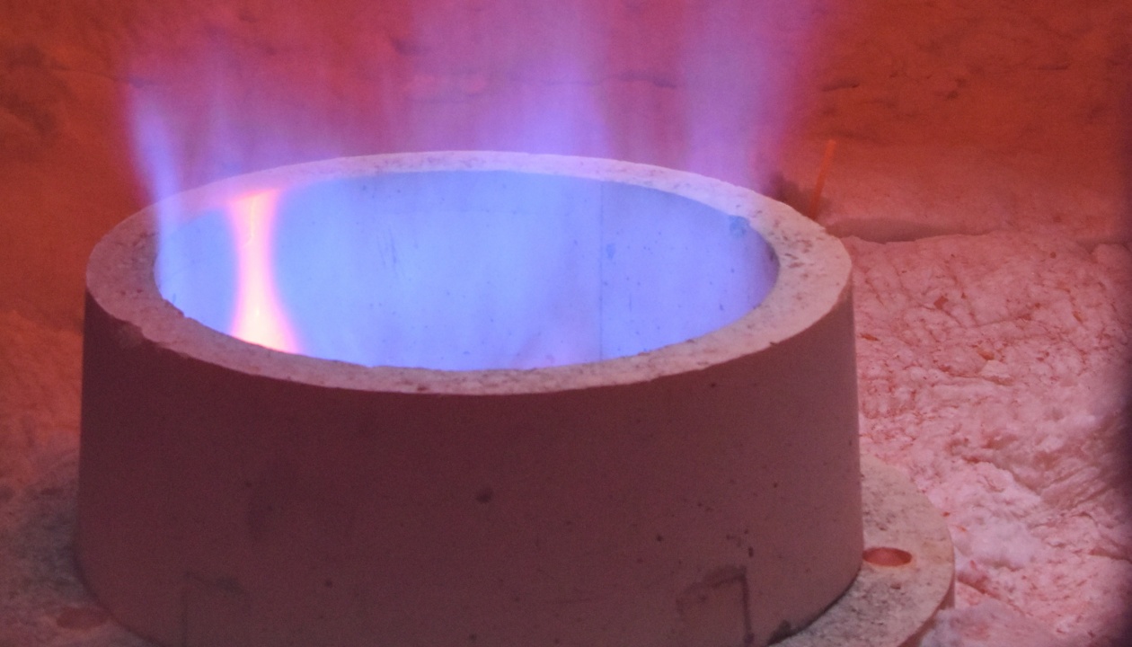 a blue flame in a fire pit