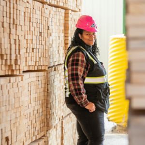 a woman wearing a hard hat and a safety vest