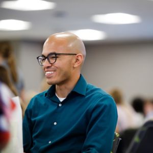 a man in a blue shirt smiling