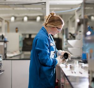 a woman in a blue lab coat