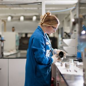 a woman in a blue lab coat
