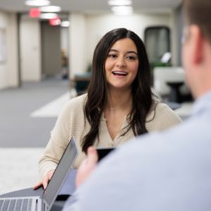 a woman talking to a man