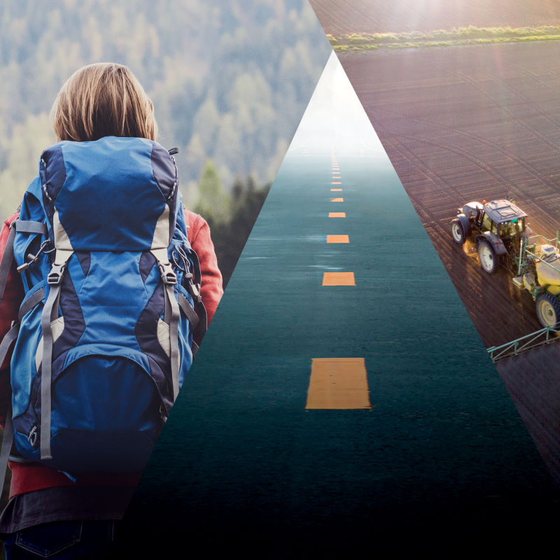 a woman walking on a road with tractor