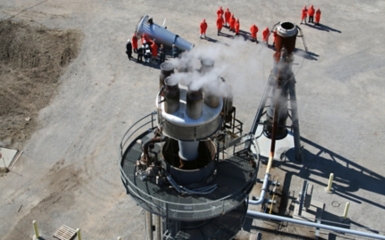 a group of people standing around a factory