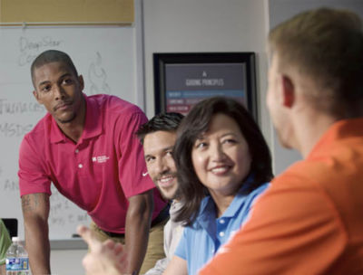 a group of people talking to each other