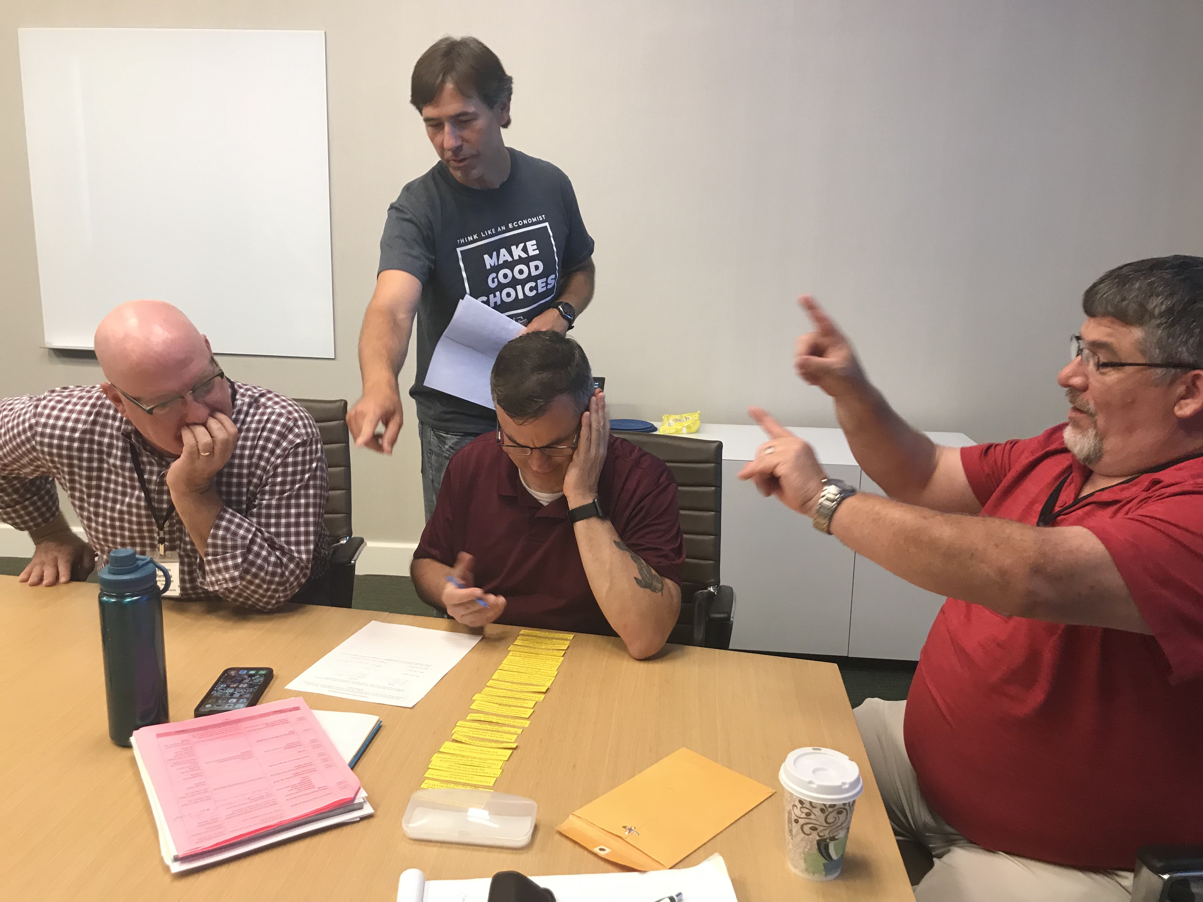 Dr. Chris Cannon, Associate Director and Chief Program Officer of the GCEE helps some teachers with their group activity.